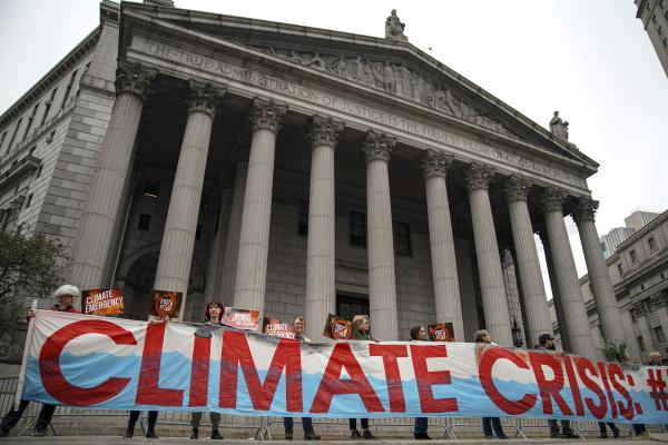 Environmental activists rally for accountability for fossil fuel companies outside of the New York Supreme Court on October 22, 2019, in New York City. (Drew Angerer via Getty Images)