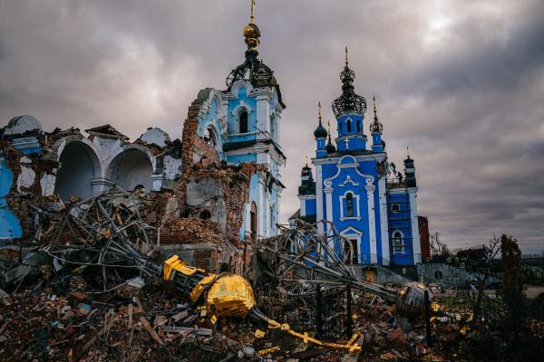 Construction workers climb onto the roof of a destroyed church on January 4, 2023, in the village of Bohorodychne, Donetsk region. (Dimitar Dilkoff/AFP via Getty Images)