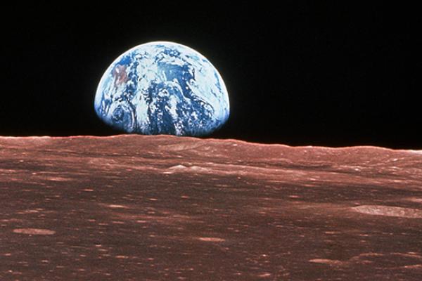 Apollo 11 view of the Earth rising over the surface of the moon