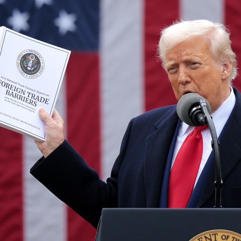  U.S. President Donald Trump holds up a copy of a 2025 National Trade Estimate Report as he speaks during a “Make America Wealthy Again” trade announcement event in the Rose Garden at the White House on April 2, 2025 in Washington, DC. Touting the event as “Liberation Day”, Trump is expected to announce additional tariffs targeting goods imported to the U.S. (Photo by Chip Somodevilla/Getty Images)